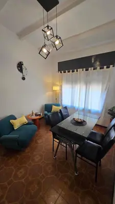 a living room with a couch and a table and chairs at Temporario HOSPITAL PRIVADO, QUALITY, con cochera en CORDOBA in Cordoba