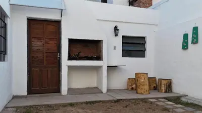 a white building with a door and a window at Temporario HOSPITAL PRIVADO, QUALITY, con cochera en CORDOBA in Cordoba