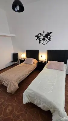two beds sitting next to each other in a room at Temporario HOSPITAL PRIVADO, QUALITY, con cochera en CORDOBA in Cordoba