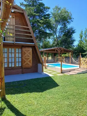 a house with a pool and a pavilion at Cabañas Mairu in Potrero de Garay