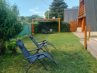 a pair of chairs sitting in a yard at Cabañas Mairu in Potrero de Garay