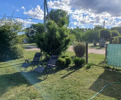 two chairs sitting in the grass in a yard at Cabañas Mairu in Potrero de Garay