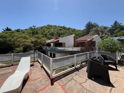 a patio with two benches and a fence at Casa TOKIO in Villa Carlos Paz