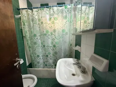 a bathroom with a sink and a shower curtain at Casa TOKIO in Villa Carlos Paz