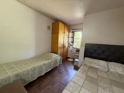 a bedroom with two beds and a window at Casa TOKIO in Villa Carlos Paz