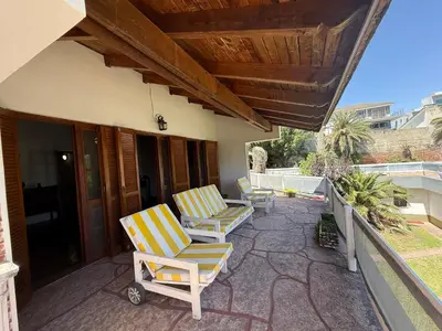 two lounge chairs on a patio with a roof at Casa TOKIO in Villa Carlos Paz