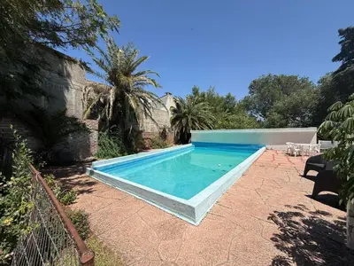 a swimming pool in the backyard of a house at Casa TOKIO in Villa Carlos Paz