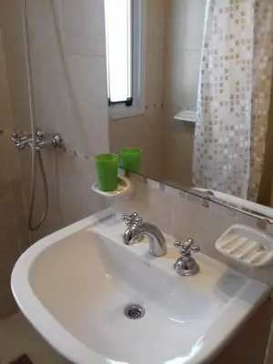 a white sink in a bathroom with a mirror at Temporario en Villa Sol in Cordoba