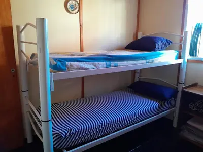 two bunk beds in a room with blue pillows at Mateo y Stella 3 in Bialet Massé