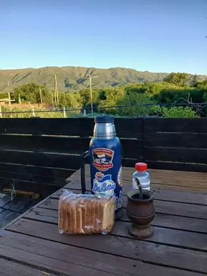 a blue bottle of milk and a container on a table at Mateo y Stella 3 in Bialet Massé