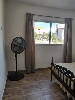 a bedroom with a fan next to a window at Mi Destino in Tanti Nuevo