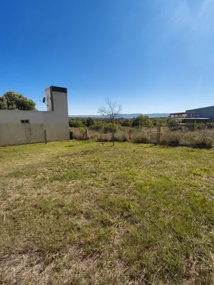 a field of grass with a building in the background at Mi Destino in Tanti Nuevo