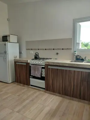 a kitchen with a stove and a refrigerator at Mi Destino in Tanti Nuevo