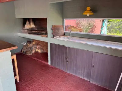 a kitchen with a stove and a fire place at Casa privada con piscina y quincho Altavip in Villa Cura Brochero