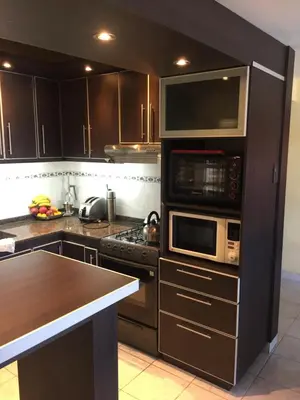 a kitchen with stainless steel appliances and a counter at Casa privada con piscina y quincho Altavip in Villa Cura Brochero