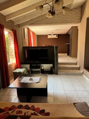 a living room with a fireplace and a tv at Casa privada con piscina y quincho Altavip in Villa Cura Brochero