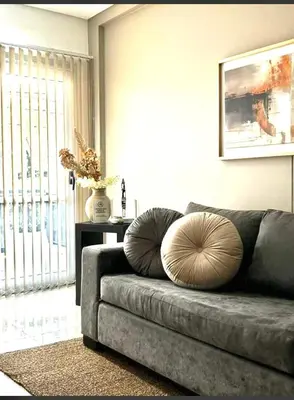 a couch with two pillows on it in a living room at Departamento Premiun con Cochera en Villa Dolores in Villa Dolores