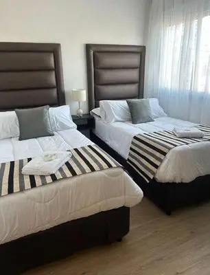 two beds sitting next to each other in a bedroom at Departamento Premiun con Cochera en Villa Dolores in Villa Dolores