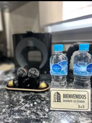 two bottles of water sitting on top of a counter at Departamento Premiun con Cochera en Villa Dolores in Villa Dolores