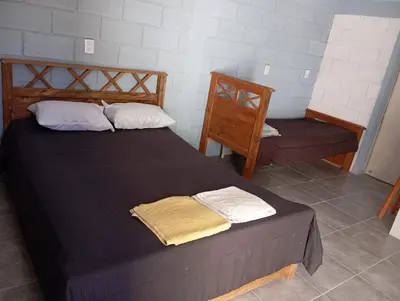 a bedroom with a large bed with two pillows at Monoambiente cosquin in Cosquín