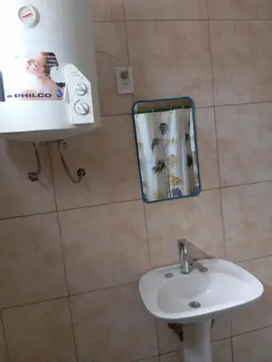 a bathroom with a sink and a mirror at Monoambiente cosquin in Cosquín