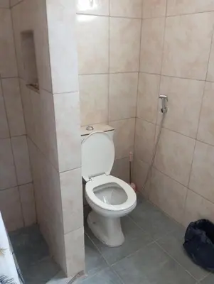 a bathroom with a white toilet in a stall at Monoambiente cosquin in Cosquín