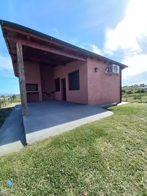a house with a large driveway in front of it at La Tranquila in Villa Yacanto