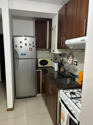 a kitchen with a refrigerator and a stove at Dpto Carlos Paz in Villa Carlos Paz