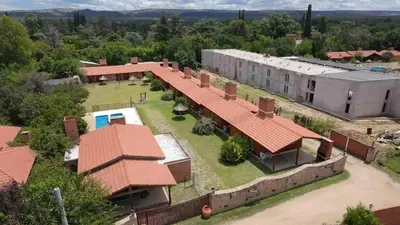 an aerial view of a building with a yard at Shanti Cabañas in Mina Clavero