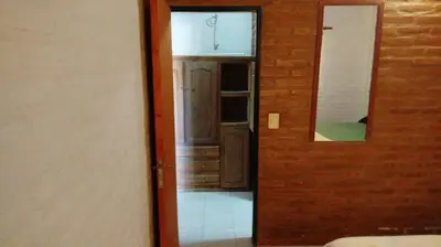 an open door to a room with a mirror at Shanti Cabañas in Mina Clavero