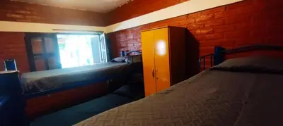 a bedroom with a bed and a window at Habitación Compartida Tipo Hostel para los más aventureros in Nono