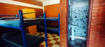 a room with two bunk beds and a shower at Habitación Compartida Tipo Hostel para los más aventureros in Nono
