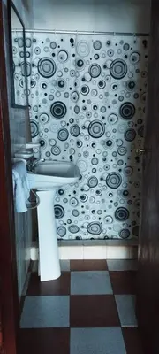 a bathroom with a sink and a black and white wall at Habitación Compartida Tipo Hostel para los más aventureros in Nono