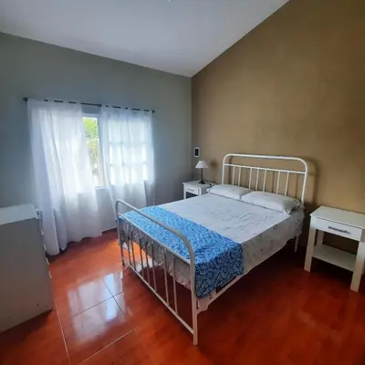 a bedroom with a white bed in a room at El sueño de papá in Santa María