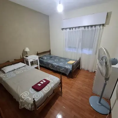 a small room with two beds and a fan at El sueño de papá in Santa María