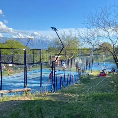 a group of people playing in a pool at a park at La Cuesta in Villa Cura Brochero