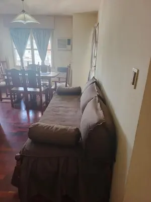a bed with pillows on it in a room at Departamento 2 dorm frente patio olmos in Cordoba