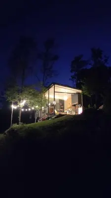 a house is lit up at night at La Preta, casa de campo in San Clemente