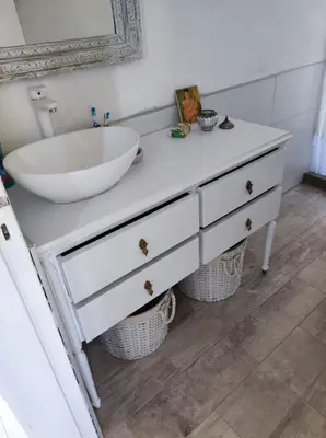 a bathroom with a white sink and a tub at La Preta, casa de campo in San Clemente