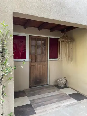 a front door of a home with a checkered floor at Departamento espacioso con gran patio para disfrutar MAYU SUMAJ in San Antonio de Arredondo