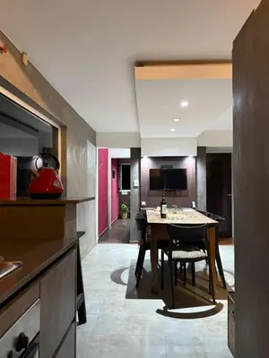 a kitchen with a table and a dining room at Departamento espacioso con gran patio para disfrutar MAYU SUMAJ in San Antonio de Arredondo