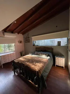 a bedroom with a large bed in a room at Departamento espacioso con gran patio para disfrutar MAYU SUMAJ in San Antonio de Arredondo
