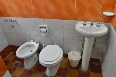 a bathroom with a toilet and a sink at Departamento Parra in Panaholma