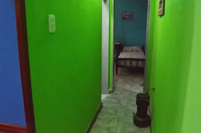 a green hallway with a room with a green wall at Departamento Parra in Panaholma