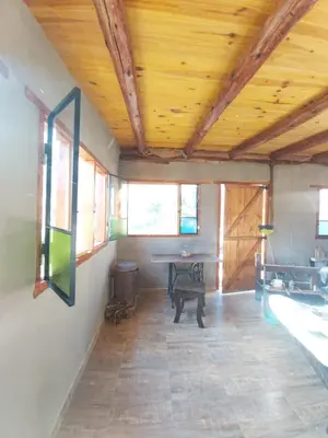 a room with a wooden ceiling with a table in it at Pie de Sierra in Los Hornillos
