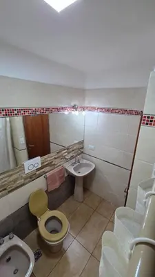 a bathroom with a sink and a toilet and a bidet at Dpto a pasos de la peatonal in Villa Carlos Paz