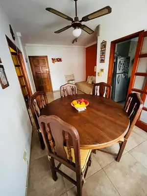 a dining room with a wooden table and chairs at Dpto a pasos de la peatonal in Villa Carlos Paz