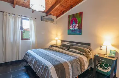 a bedroom with a bed and two lamps and a window at Tierras de Breena in Los Reartes