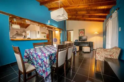 a kitchen and dining room with a table and chairs at Tierras de Breena in Los Reartes