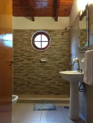 a bathroom with a sink and a window at Tierras de Breena in Los Reartes